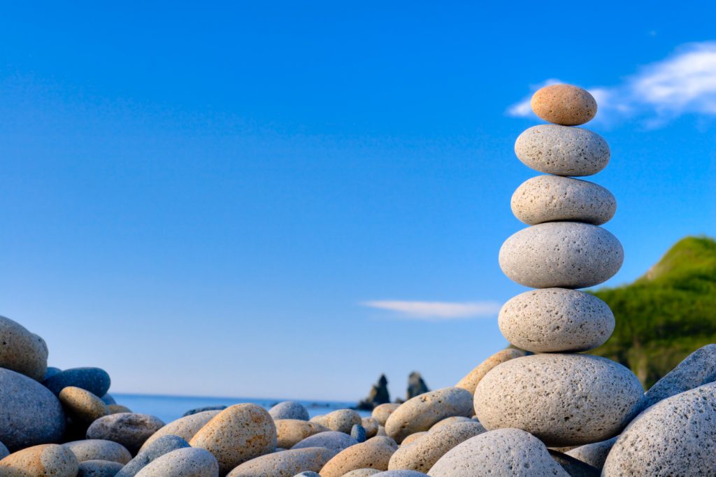 aufeinandergestapelte Steine am Meer - Energy in Balance